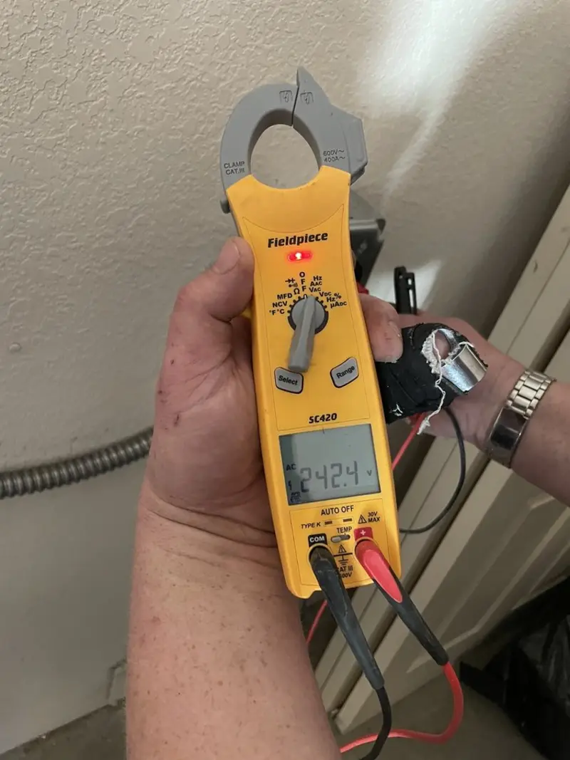 Voltage testing with clamp meter during Electrical Installation Services in Mantua